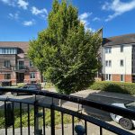View of residential street from a balcony.