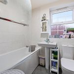 Modern bathroom with bathtub, sink, and toilet