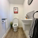 Minimalist bathroom with toilet and sink.