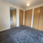 Empty room with built-in wardrobes and en-suite bathroom.