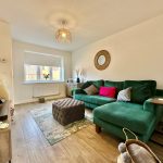 Cosy living room with green sofa and decor.