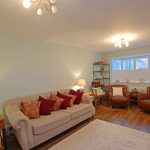 Cosy living room with sofa and armchairs.