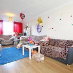 Cosy living room with festive balloons and decor.