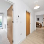 Bright hallway with open bedroom and dining view