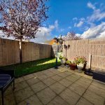 Tranquil garden patio with plants and seating area.