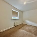Empty room with carpet and window.
