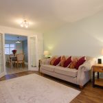 Comfortable living room with sofa and dining area.