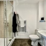 Modern bathroom with shower and towel rail