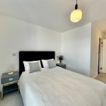 Modern bedroom with double bed and bedside tables.