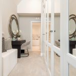 Elegant dressing room with mirrors and seating area.