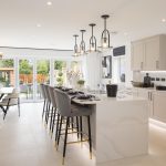 Modern kitchen with island and dining area.