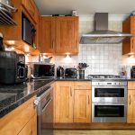 Modern kitchen with wooden cupboards and appliances.