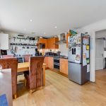 Modern kitchen with appliances and dining area.