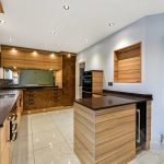 Modern kitchen with wooden cabinets and sleek design.