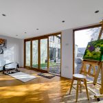 Bright art studio with easels and paintings.