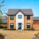 Modern brick house with driveway in suburbia.