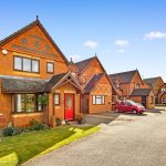 Red-brick houses in a suburban neighbourhood.