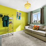 Bright living room with sofa and colourful decor.