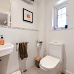 Modern bathroom with toilet and sink.
