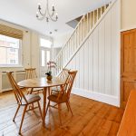 Cosy dining area with round table and chairs.
