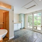 Bright kitchen with tiled floor and garden view.