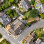 Aerial view of residential houses and green gardens.