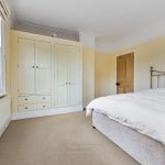 Bright bedroom with wardrobe and bed