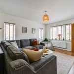 Bright, modern living room with grey sofa and decor.