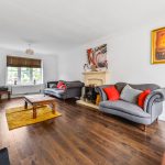 Cosy living room with sofas and fireplace.