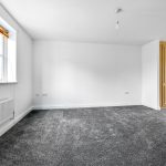 Empty room with grey carpet and window light