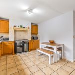 Spacious kitchen with wooden cabinets and dining area.