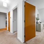 Bright hallway with open doors and modern decor.
