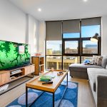 Modern living room with TV, sofa and coffee table.