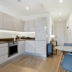 Modern kitchen with dining table and chairs.
