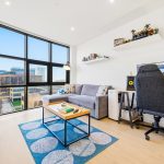 Modern living room with large windows and desk