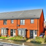 Modern red brick terraced houses with front gardens.