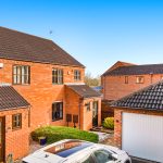 Brick houses with garages and car in driveway