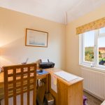 Home office with desk, chair, and printer.