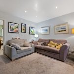 Cozy living room with sofas and framed artwork.