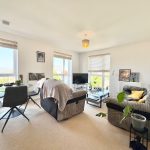 Bright living room with modern furniture and windows.