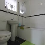 Modern white bathroom with toilet and sink