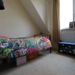 Child's room with superhero-themed bedding.