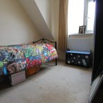 Bright kid's room with superhero bedding.