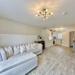 Modern open-plan living room with light decor.