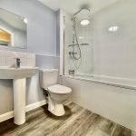 Modern bathroom with shower and bathtub combination.