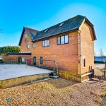 Detached brick house with patio and garden