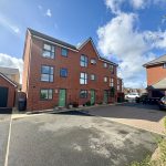 Modern red-brick houses with parking area.