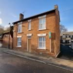 Traditional brick house in a quiet UK street.