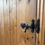 Wooden door with black metal latch