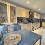 Modern kitchen with wooden cabinets and appliances.